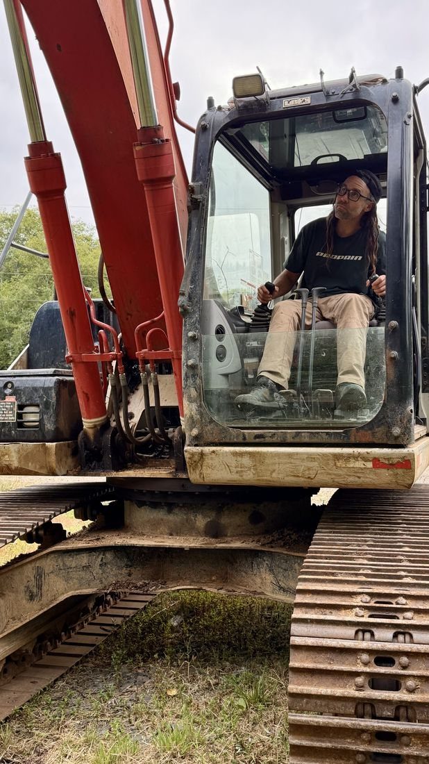 Ryan Rodriguez operating an excavator while building trail at Buzzard Butte